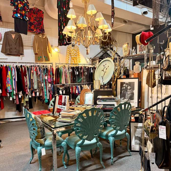 Vintage store interior with furniture, clothing, and decorative items.