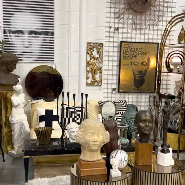 Photo of a vendor booth with an assortment of lamps and sculptures