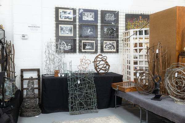 Photo of a vendor booth with an assortment of metal sculptures